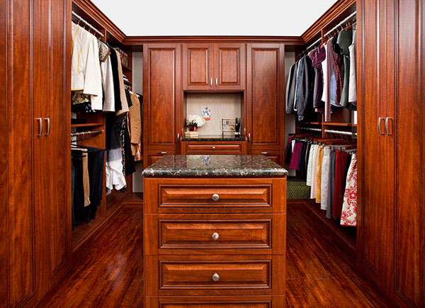 Walk-in closet with center island, cabinets and wardrobe